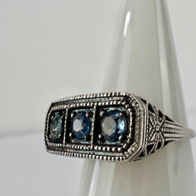 Load image into Gallery viewer, Vintage sterling silver filigree ring with three blue stones - size 8.This vintage sterling silver ring features three blue round cut stones set in a delicate filigree setting. Round cut, prong set stones, with an open back.  Excellent vintage condition. Perfect gift for a mother of 3 for Mother&#39;s day! 
