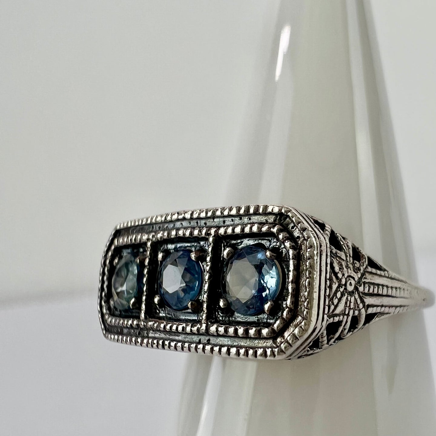 Vintage sterling silver filigree ring with three blue stones - size 8.This vintage sterling silver ring features three blue round cut stones set in a delicate filigree setting. Round cut, prong set stones, with an open back.  Excellent vintage condition. Perfect gift for a mother of 3 for Mother's day! 