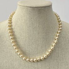 Load image into Gallery viewer, Retro Knotted Faux Pearl Necklace with gold tone filigree push lock closure. 
